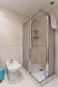 a bathroom with a shower and a toilet and a sink at VIVIENDA con INCREIBLES VISTAS A LA PLAYA DE RIAZOR in A Coruña +21 photos