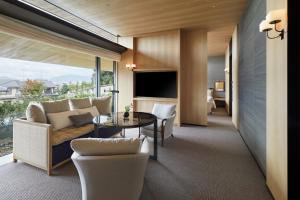 a living room with a couch and a table at Park Hyatt Kyoto in Kyoto