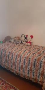 a group of stuffed animals sitting on top of a bed at Guest House OTILIA in Gyumri