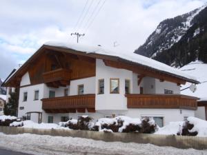 a house with snow on the top of it at Appartement Mair in Sankt Leonhard im Pitztal