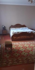 a bedroom with a bed and a rug at Guest House OTILIA in Gyumri