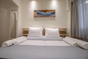 A bed or beds in a room at Levkosh Apartments at Lefkada's Heart
