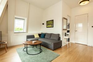 
a living room with a couch and a table at Stayci Serviced Apartments Central Station in The Hague
