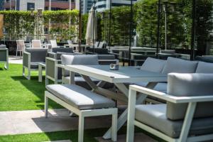 a group of tables and chairs on the grass at Signature 1 Hotel Tecom in Dubai