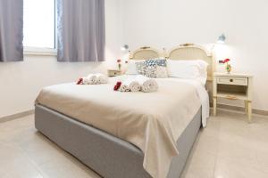 a bedroom with a large bed with towels on it at Don Vittorio Country Village in Taormina