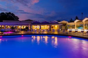 a swimming pool with blue lights in a resort at Hotel Mioni Royal San in Montegrotto Terme