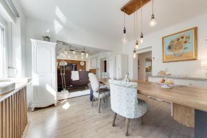 a kitchen and living room with a table and chairs at Amazing Apartment in Downtown Maribor in Maribor