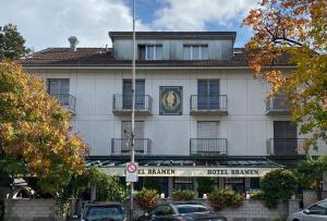 a building with a clock on the front of it at Hotel Bramen in Kloten