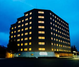 a large black building with lights on at Sakura Terrace in Kyoto