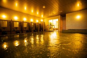 a bathroom with a row of urinals in a building at Sakura Terrace in Kyoto