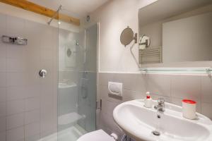 a bathroom with a sink and a shower and a toilet at HT Residence Maximus in Rome