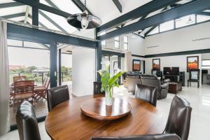 a dining room with a wooden table and chairs at FC14 - Pezula Ocean & Valley Views in Knysna