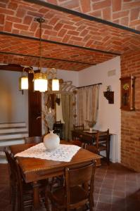 a dining room with a table with a vase on it at La Corte Di Gerardo in Tonco