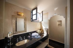a bathroom with a sink and a mirror at Riad Star by Marrakech Riad in Marrakech