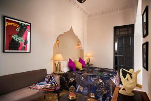 a bedroom with a bed and a couch in a room at Riad Star by Marrakech Riad in Marrakech