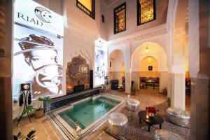 a large room with a pool in a building at Riad Star by Marrakech Riad in Marrakech