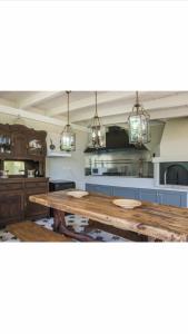a large kitchen with a wooden table in it at Fanari House in Argostoli +8 photos