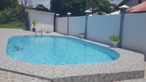 a swimming pool in the middle of a backyard at Ma Chambre d’Hôte in Rémiré