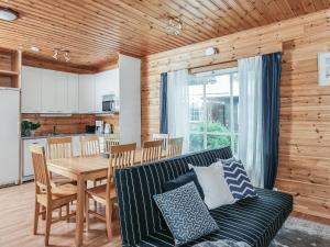 a living room with a couch and a table at Holiday Home B by Interhome in Porvoo