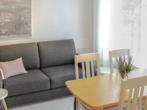 a living room with a couch and a table at Holiday Home Kanerva 202 by Interhome in Äkäslompolo