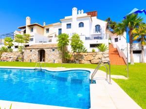 a villa with a swimming pool in front of a house at Holiday Home Creativo by Interhome in La Herradura