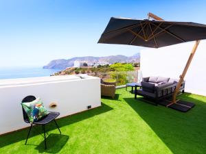a patio with an umbrella and a table and chairs at Holiday Home Creativo by Interhome in La Herradura