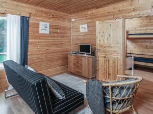 a living room with a couch and a computer monitor at Holiday Home B by Interhome in Porvoo