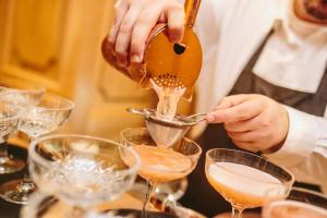 a person is pouring champagne into glasses on a table at The Scotsman Hotel in Edinburgh