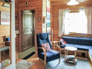 a living room with a couch and a table at Holiday Home Ylläsmukka a 3 by Interhome in Äkäslompolo