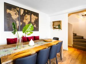 a dining room with a wooden table and blue chairs at Holiday Home Creativo by Interhome in La Herradura