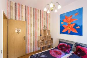 a bedroom with a bed and a painting on the wall at MW Old&New Home in Braşov