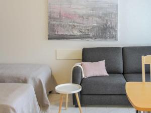 a living room with a couch and a table at Holiday Home Kanerva 202 by Interhome in Äkäslompolo