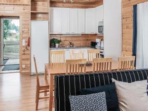 a kitchen and living room with a couch and a table at Holiday Home B by Interhome in Porvoo +17 photos