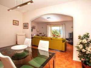 a living room with a table and a yellow couch at Holiday Home Gloria by Interhome in Calonge +19 photos