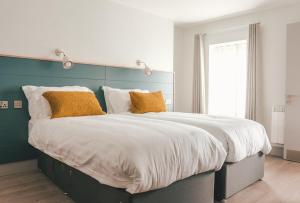Ένα ή περισσότερα κρεβάτια σε δωμάτιο στο Baginbun Lodge