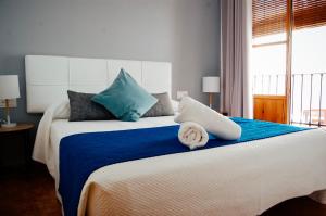 a bedroom with a large bed with blue and white at Nest Style Granada in Granada