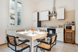 a kitchen with a table and chairs in a room at Marconi Airport Cozy Dream Flat in Bologna