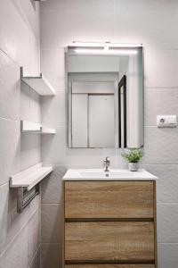 a bathroom with a sink and a mirror at SERRANO CLASS, by Presidence Rentals in Madrid
