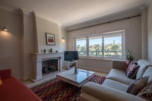 a living room with a couch and a fireplace at Farmers Market Vila Apartment in Cascais
