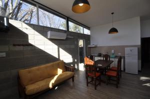 a living room with a couch and a table at Hotel y cabañas FATVIAL 4 de Abril in Tanti