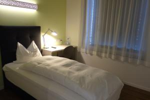Postel nebo postele na pokoji v ubytování Partner Hotel AG Zofingen