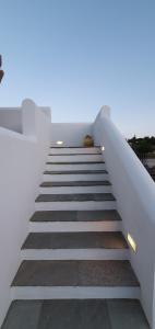 a staircase leading up to a house at Sarakiniko Rooms in Adamantas