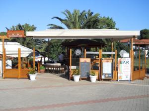 a restaurant with a white canopy and a bar at Vontzos Hotel in Achladies