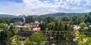 a small town in the mountains with a church at Hôtel Val-David - Appartements de la Gare in Val-David