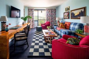 a living room with a couch and a table at Graduate Fayetteville in Fayetteville