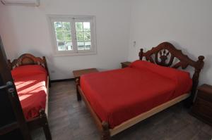 a bedroom with two beds and a window at Hotel y cabañas FATVIAL 4 de Abril in Tanti +63 photos