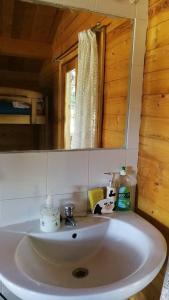 a white sink in a bathroom with a mirror at La Cabaña de Gaia in San Lorenzo de El Escorial