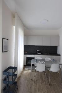 a kitchen with a table and chairs in a room at casa Agrifoglio in Terralba