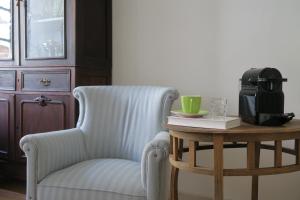 a living room with a chair and a coffee table at Azul Sul in Tavira