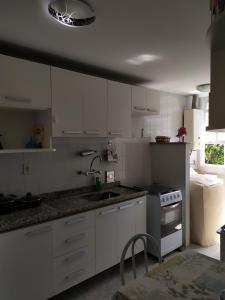 a kitchen with white cabinets and a sink at Apartamento Duplex no melhor bairro de NF in Nova Friburgo